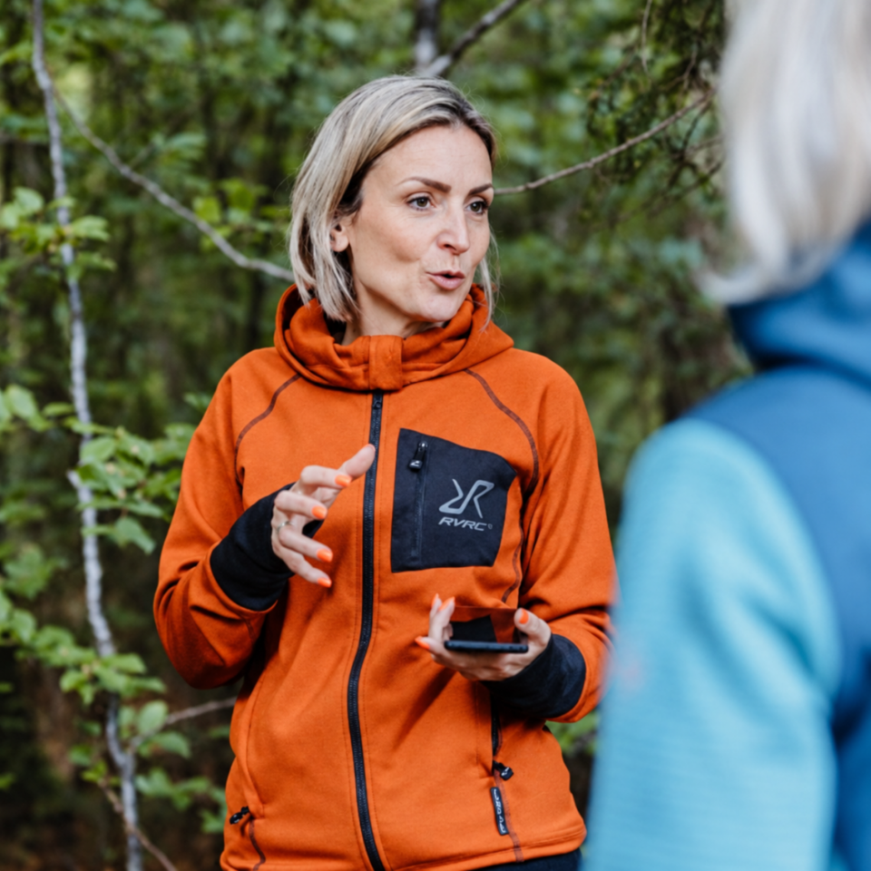 Trainerin Janine in orangefarbener Jacke beim Zughundesport